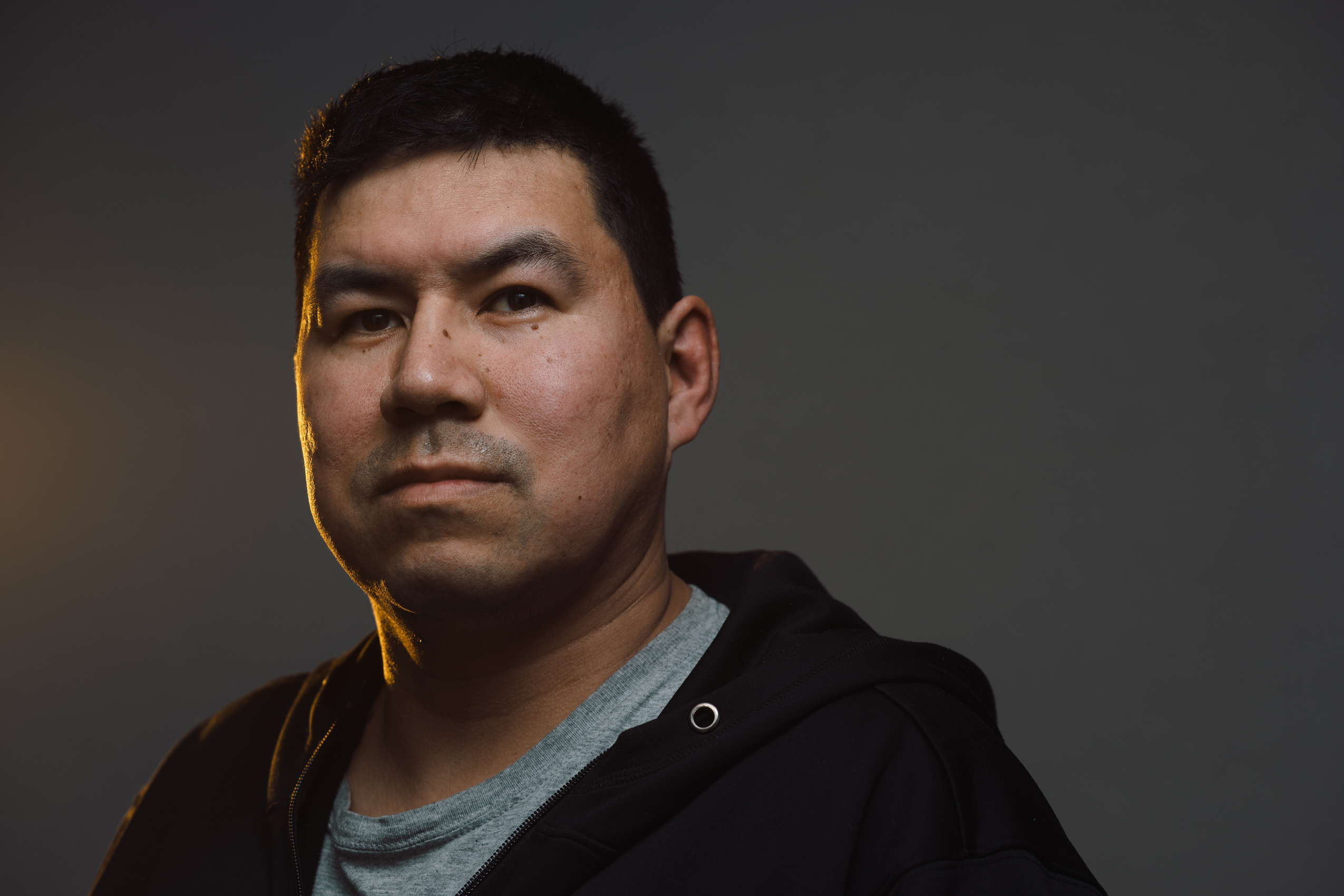 Jason Castor looks at the camera in a portrait